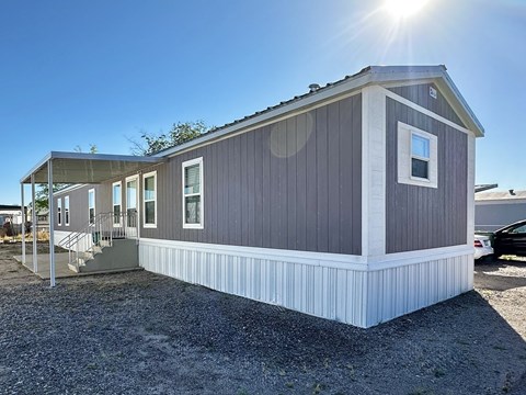 a manufactured home is shown with the sun shining
